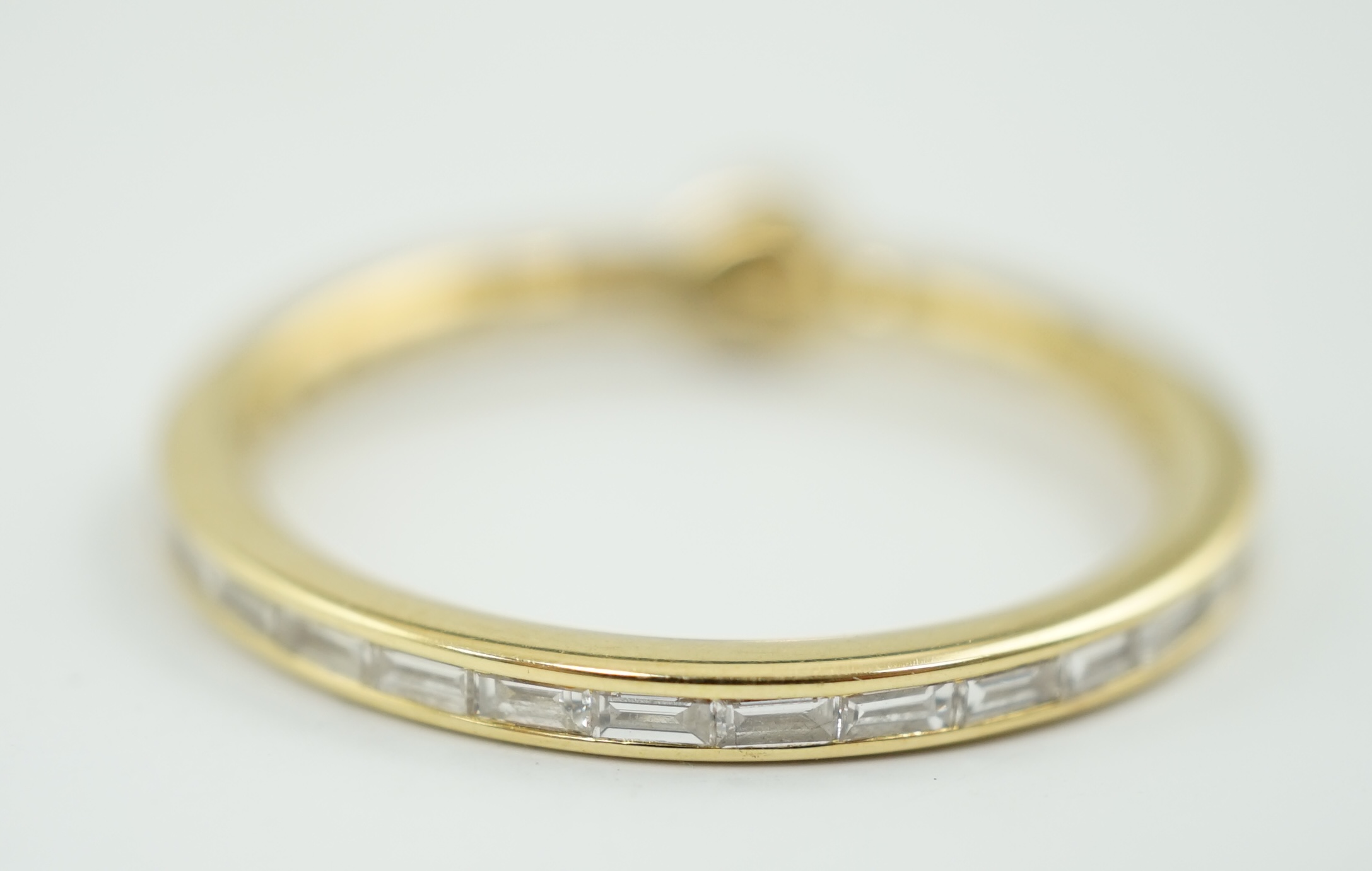 A modern 18ct gold, round and baguette cut diamond set ring